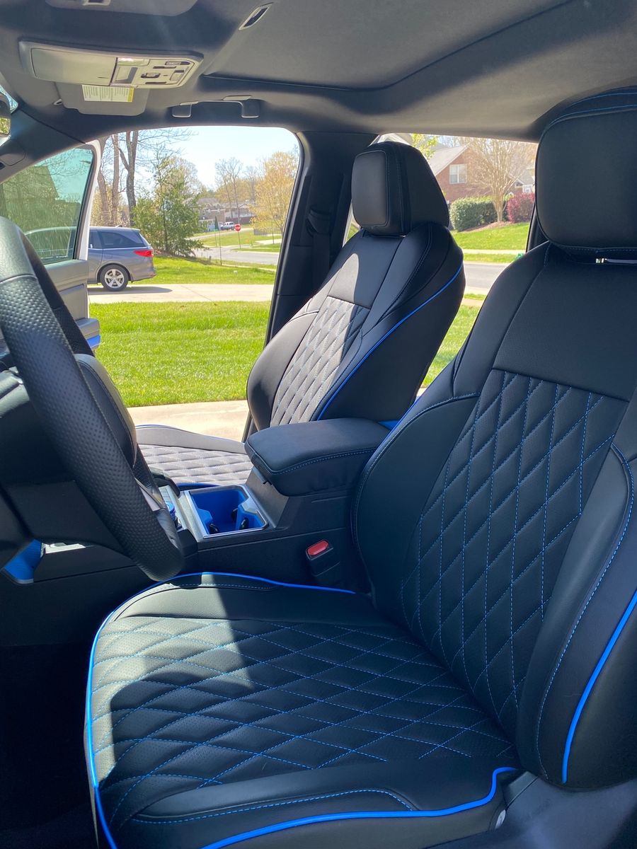 Black and blue diamond seat covers in a Tacoma