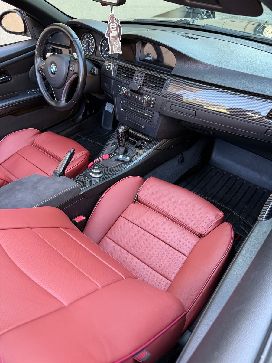 Red seat covers in a BMW interior
