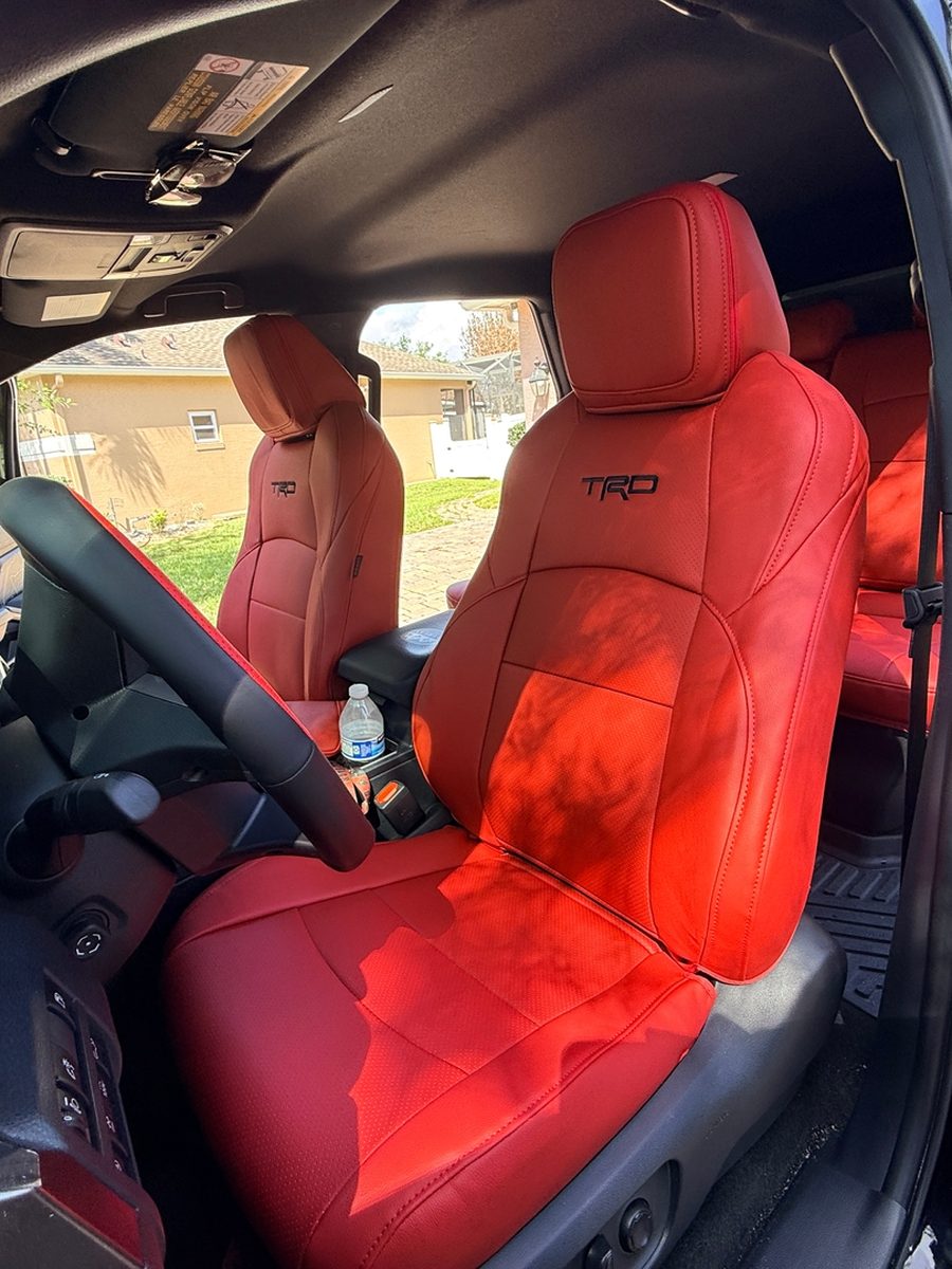 Red front seat covers in a Toyota truck