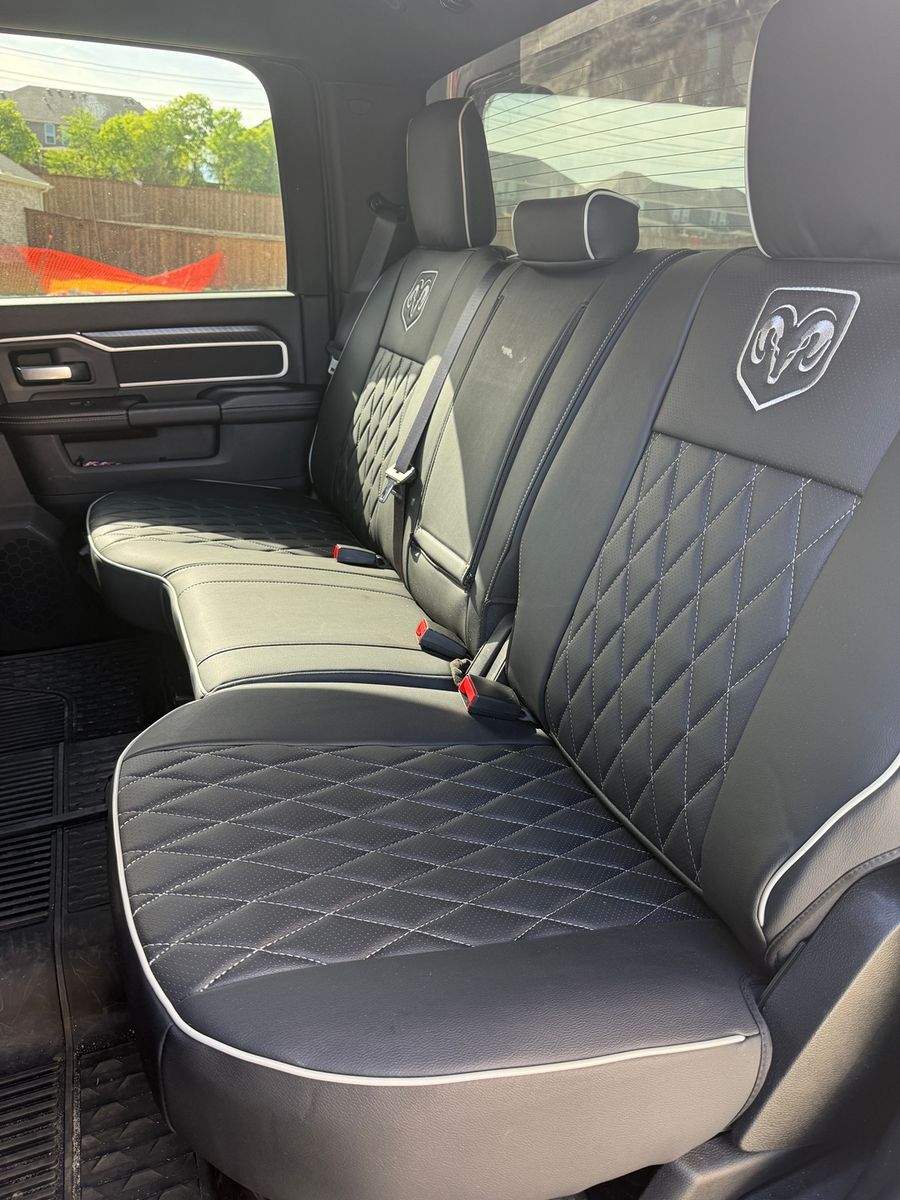 Black diamond seat covers with white piping in a RAM
