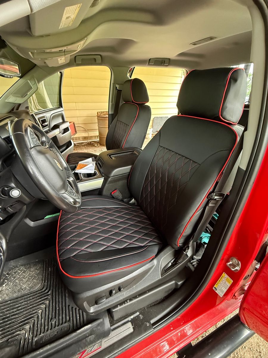Black diamond seat covers with red piping in a truck with red interior