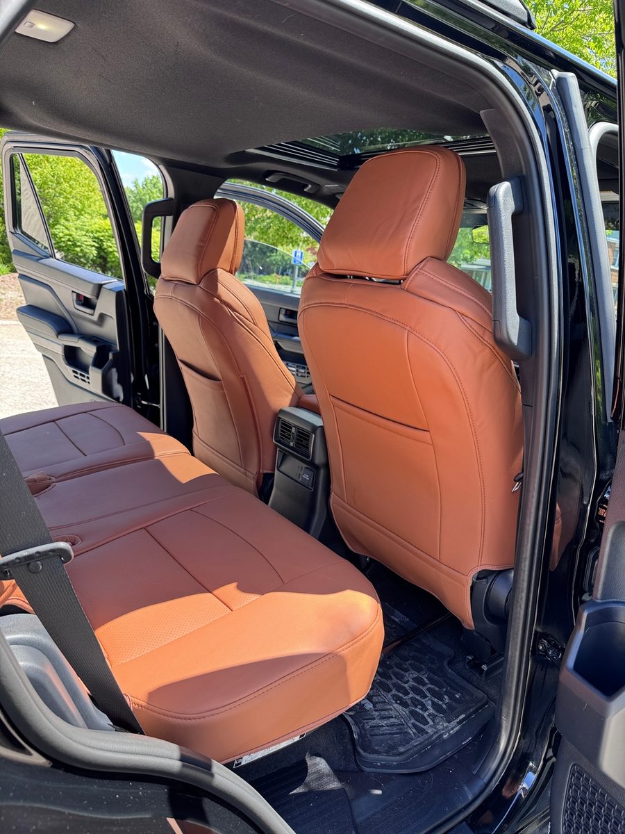 Saddle brown rear bench seat covers in a truck