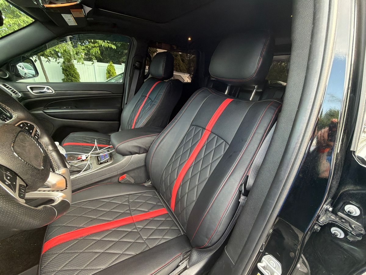 Black seat covers with a red stripe, side view