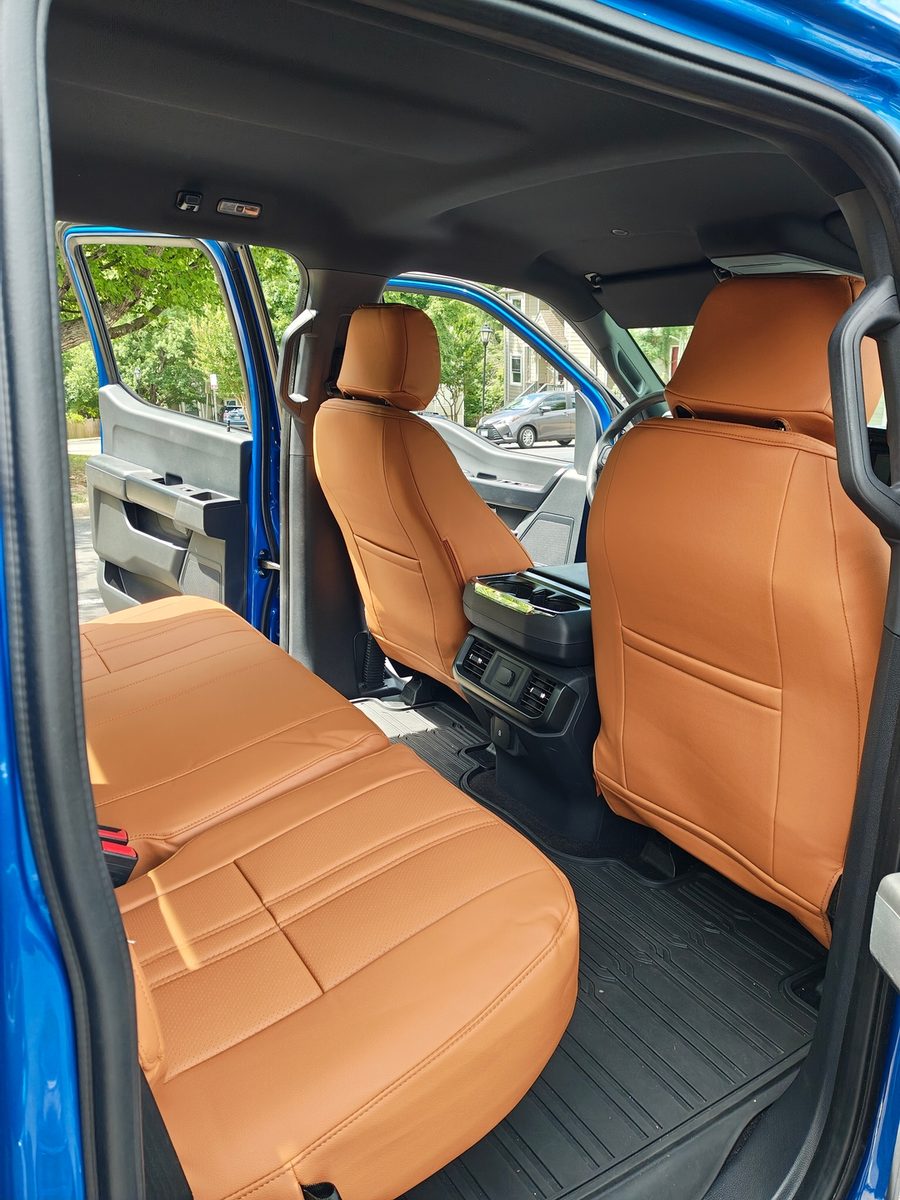 Saddle brown seat covers in a blue truck