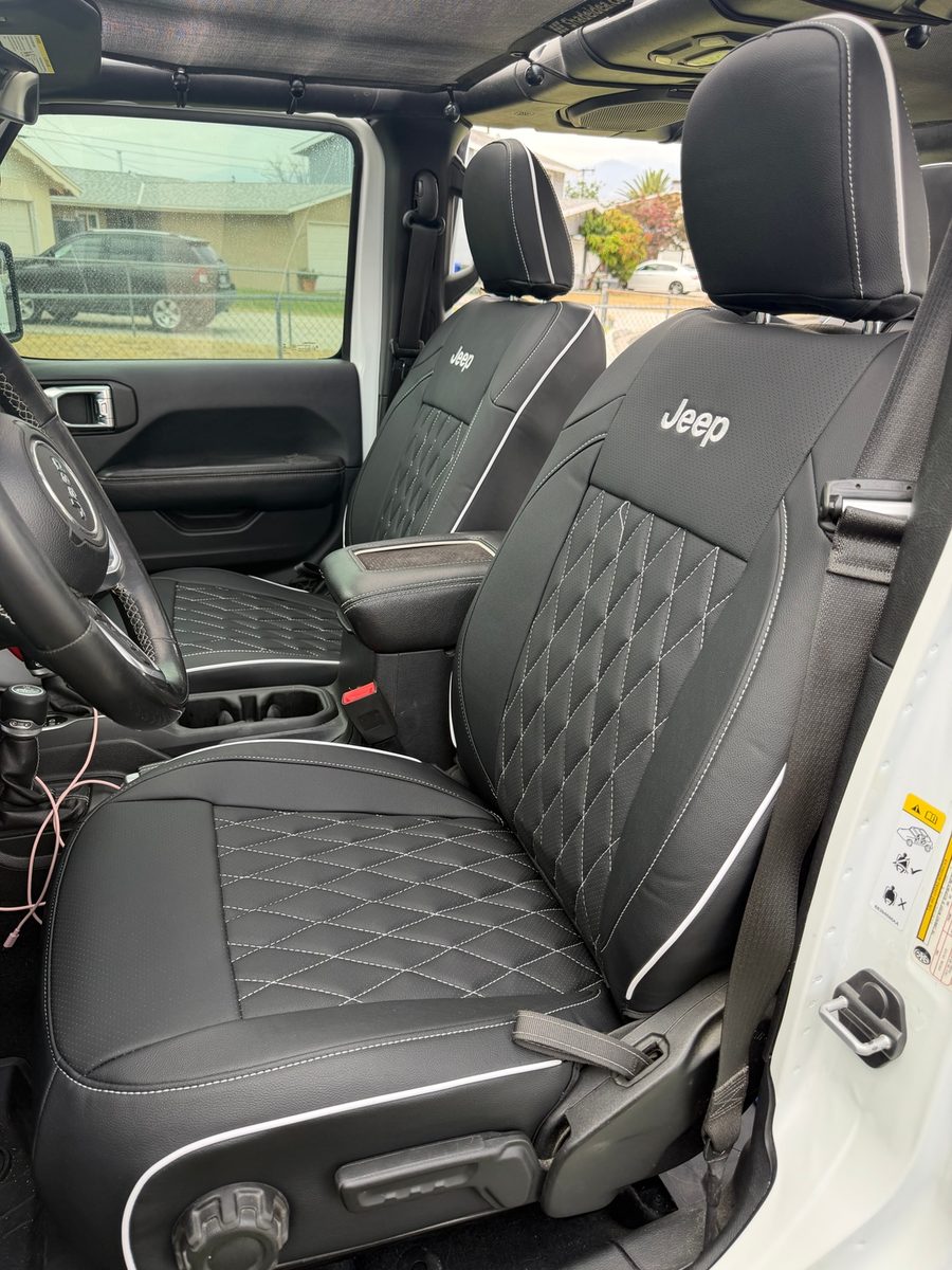 Black diamond seat covers with white piping in a Jeep