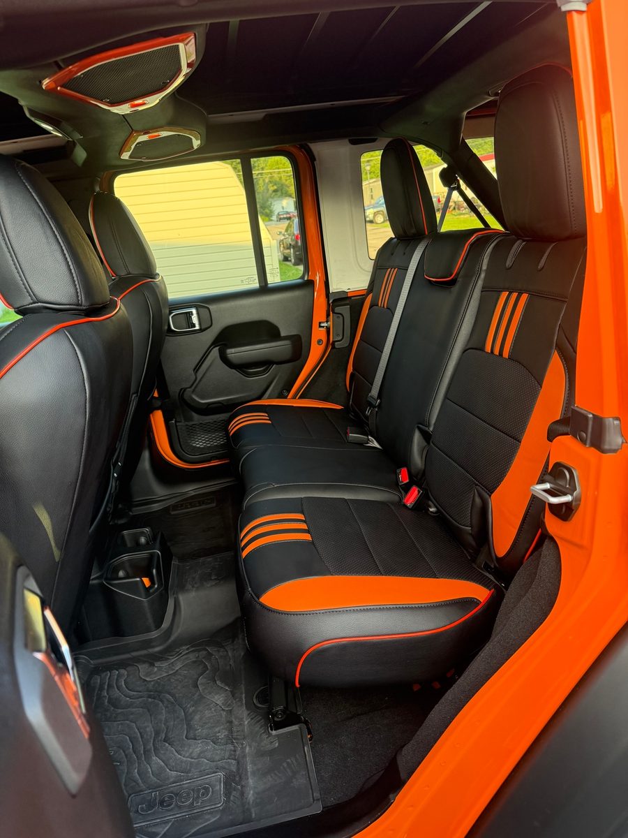 Black and orange seat covers in a Jeep Wrangler