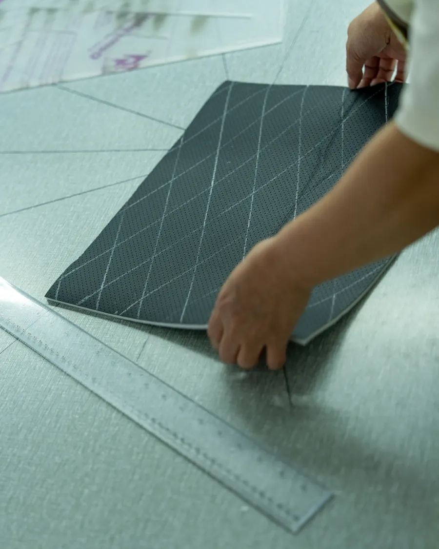 A diamond-quilted panel being squared up by hand